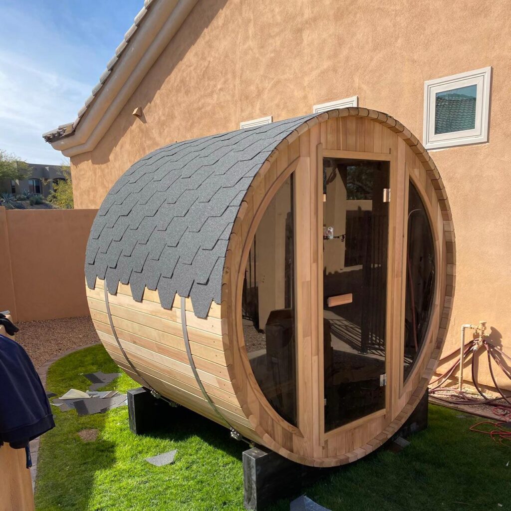 R3X rustic cedar barrel sauna in use outdoors on a residential property